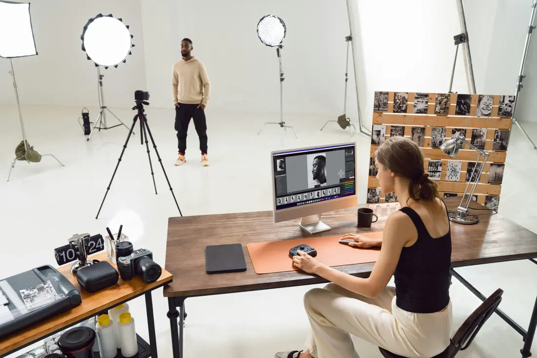 A photographer editing a shoot in the studio