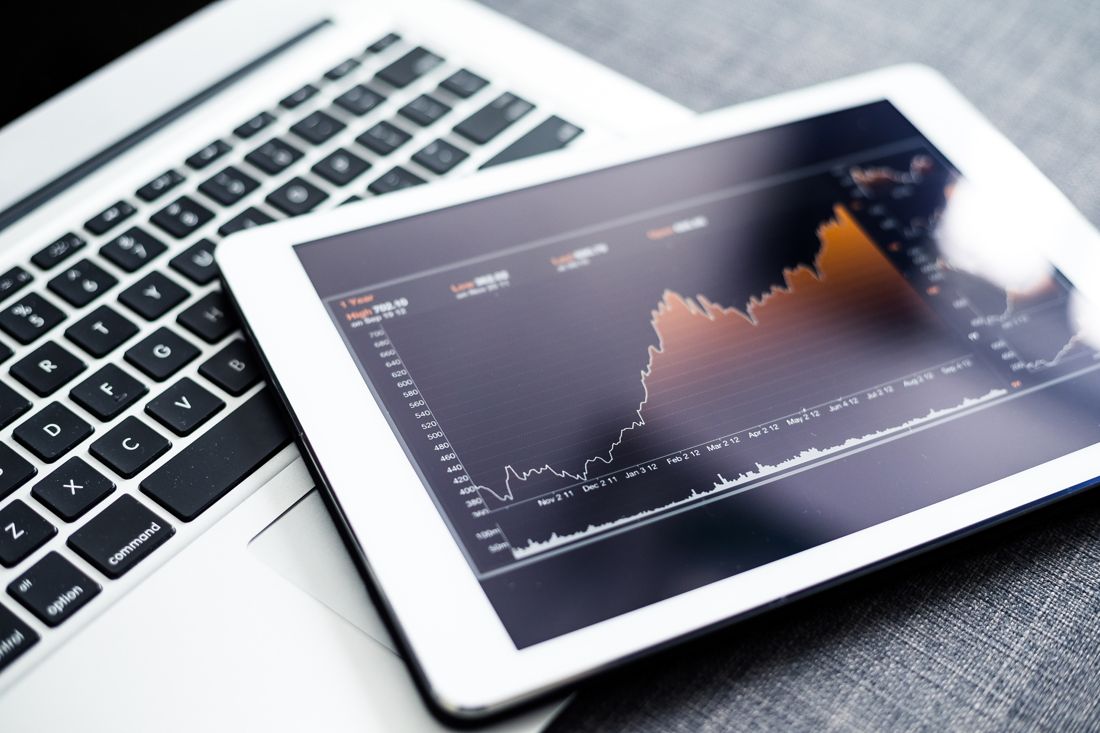 A tablet showing a rising sales chart