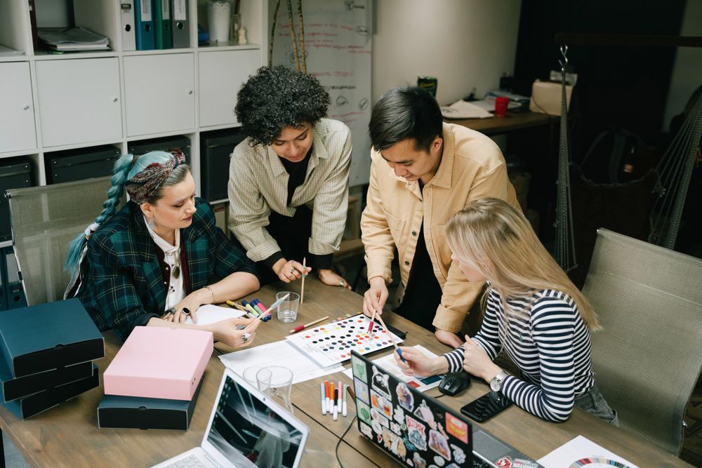 A small team planning content around a table