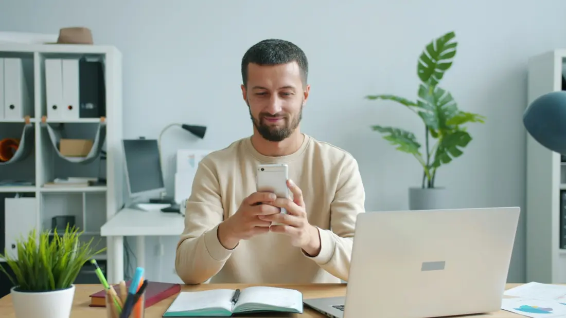 A business owner checking post ideas on a phone